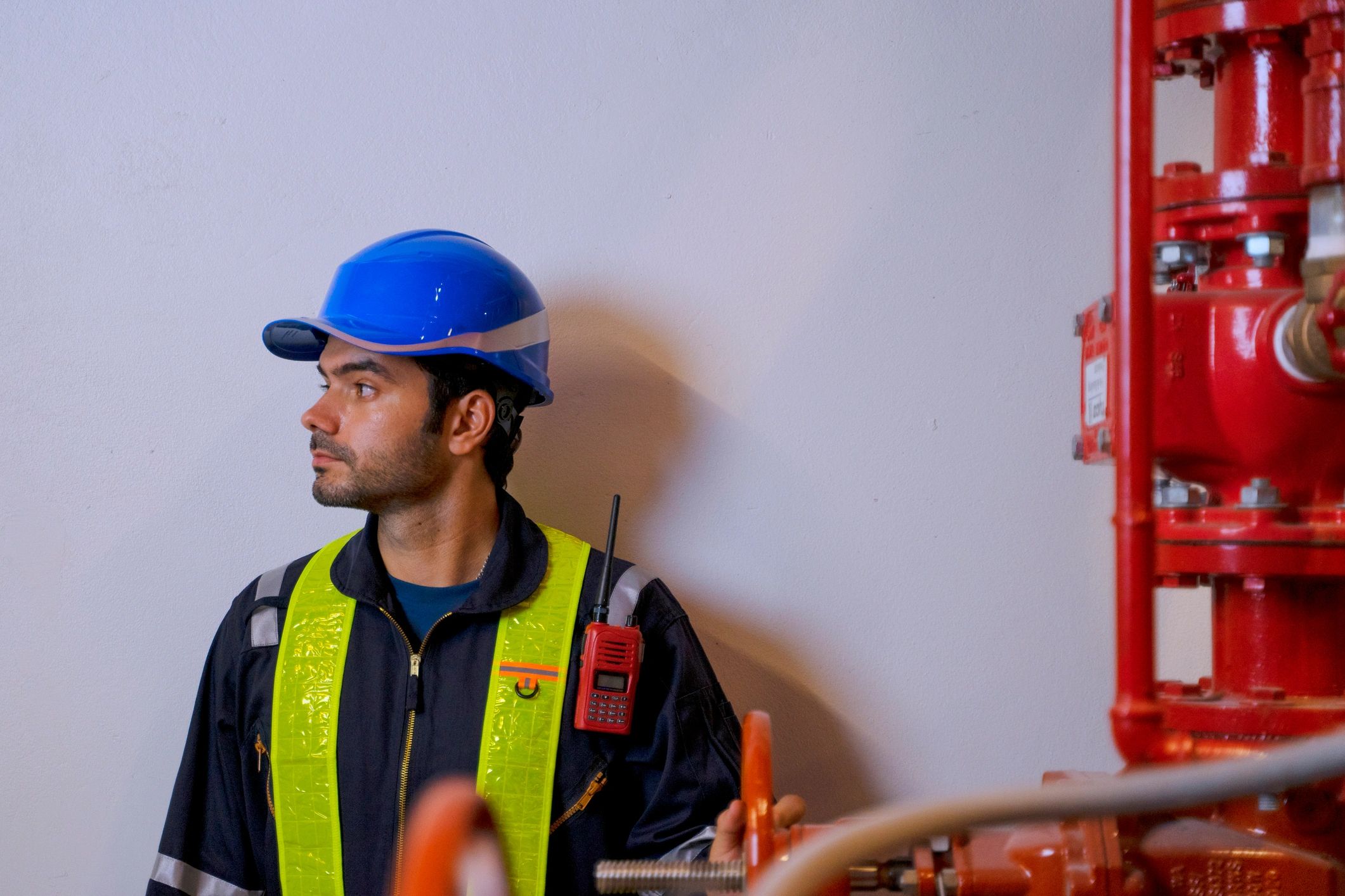 Technician working on utility systems in a basement mechanical area