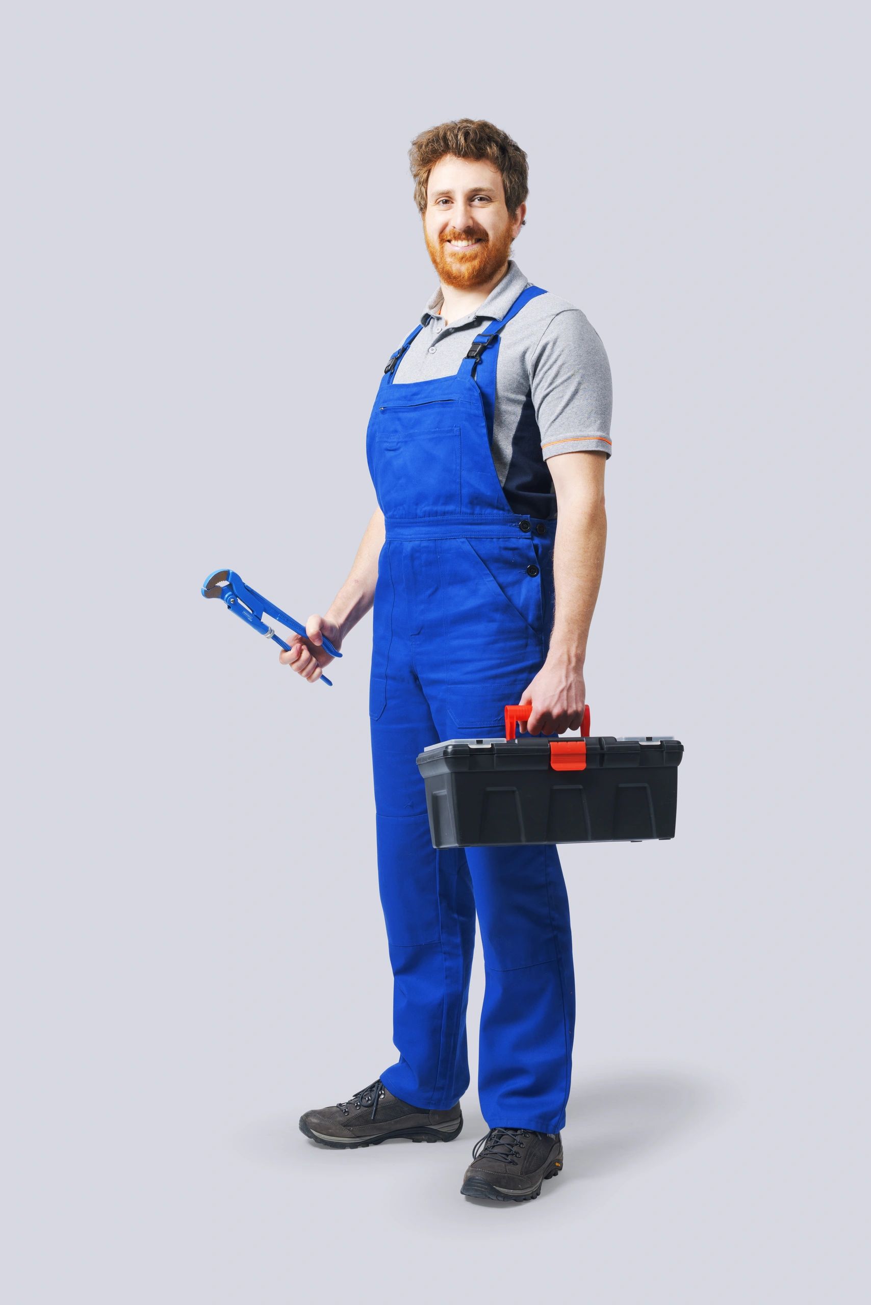 Professional plumber holding tools