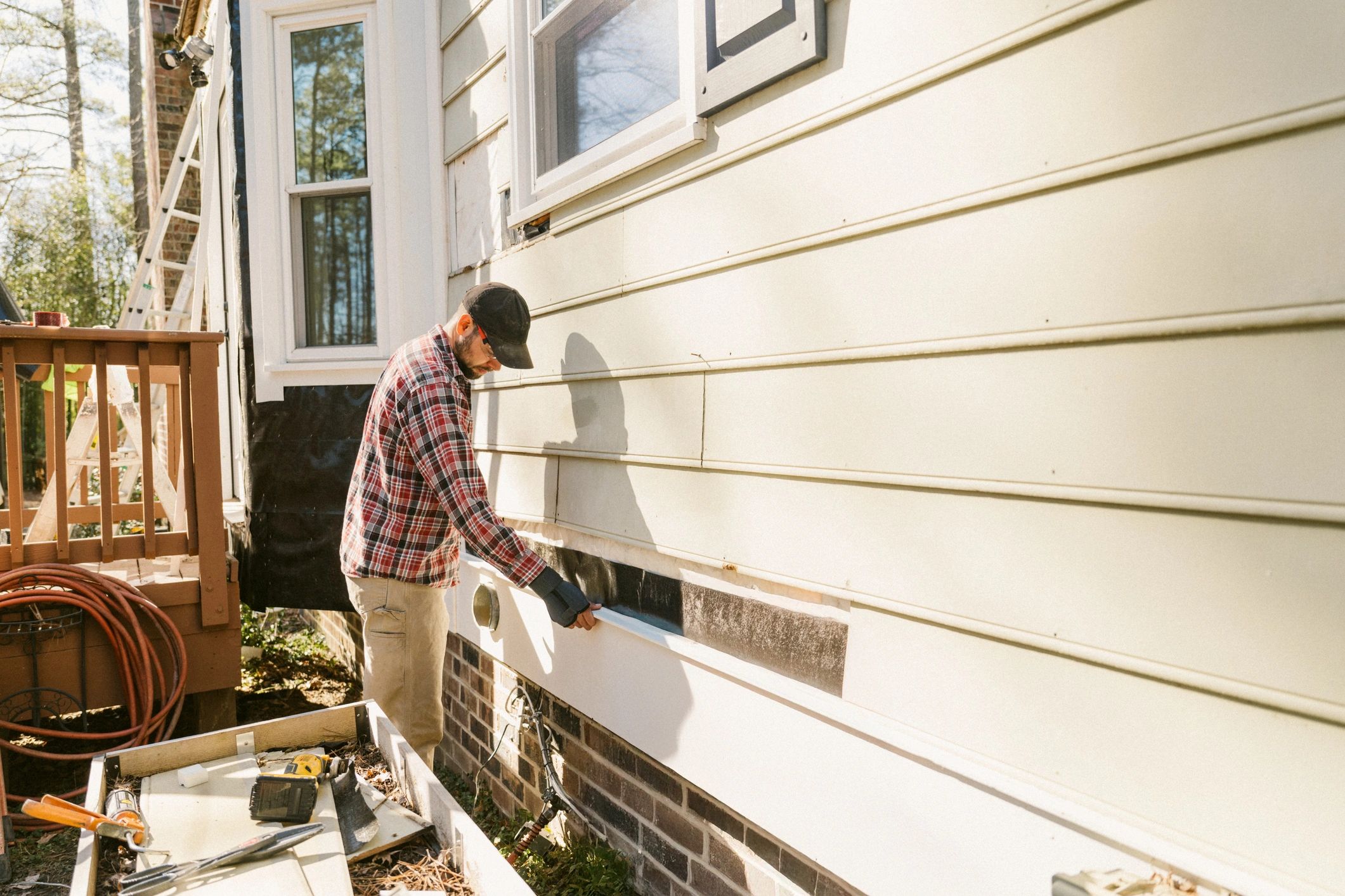 Technician working on a residential property exterior